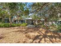 Ranch home with lush landscaping and a spacious front yard at 7536 Midnight Pass Rd, Sarasota, FL 34242