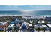 Aerial view of a charming beach house, near the ocean, with lush landscaping at 126/128 Avenida Veneccia, Sarasota, FL 34242
