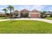 Beautiful one-story home with a large front yard and palm trees at 13207 49Th E Ln, Parrish, FL 34219