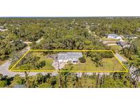 Aerial view of a single-Gathering home on a large lot with mature trees at 17402 Billiar Ave, Port Charlotte, FL 33948
