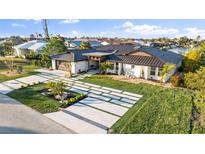 Luxury home with modern design, metal roof, and landscaped grounds at 2350 Via Venice, Punta Gorda, FL 33950