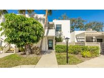 Inviting condo building exterior with lush landscaping and walkway at 307 Timberlake Dr # 307, Bradenton, FL 34210