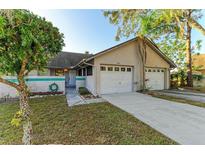 Front view of a charming house with a two-car garage and well-maintained lawn at 428 40Th W Ct, Palmetto, FL 34221