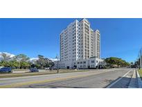 Stunning high-rise condo building with white facade and multiple balconies, set against a clear blue sky at 505 S Orange Ave # 501, Sarasota, FL 34236