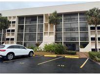 Condo building exterior with parking and landscaping at 6120 43Rd W St # 101B, Bradenton, FL 34210