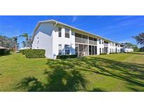 Condo building with balconies and green lawn at 6908 Drewrys Blf # 712, Bradenton, FL 34203