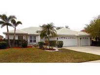 Attractive single-story home with two-car garage, landscaping, and palm trees at 7212 Southgate Ct, Sarasota, FL 34243