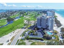 Stunning aerial view showcasing beachfront condo, pool, lush golf course and oceanfront views at 775 Longboat Club Rd # 902, Longboat Key, FL 34228