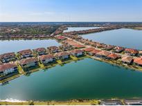 Stunning aerial view of lakeside homes with terracotta roofs in a well-maintained, planned community at 109 Porta Vecchio Bnd # 202, Nokomis, FL 34275