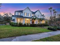 Two-story home with a metal roof and landscaped lawn at 1686 North Dr, Sarasota, FL 34239