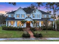 Stunning two-story home with a charming front porch and landscaped yard at 1686 North Dr, Sarasota, FL 34239