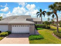 Attractive condo with 2-car garage, nicely landscaped, and walkway at 3491 Byron Ln, Longboat Key, FL 34228