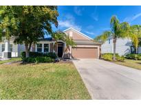 Single-story home with attached garage and landscaped lawn at 4711 Garden Arbor Way, Bradenton, FL 34203