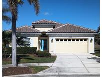 One-story house with tile roof, two-car garage, and landscaped yard at 5452 Club View Ln, North Port, FL 34287