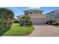 Beautiful two-story house with a large driveway and well-manicured lawn at 6920 74Th Street E Cir, Bradenton, FL 34203