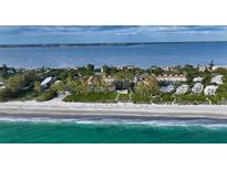 Aerial view of beachfront property with lush landscaping and ocean access at 5055 Gulf Of Mexico Dr # 411, Longboat Key, FL 34228