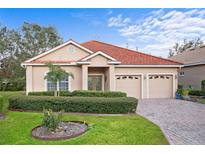 Charming single-story home featuring a terracotta tile roof, two-car garage and well-maintained landscaping at 6211 Skyward Ct, Bradenton, FL 34203