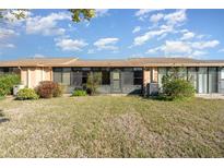 The backyard features a well-maintained lawn and a covered porch at 6314 29Th W Ave, Bradenton, FL 34209