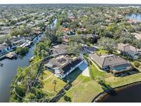 Aerial view showing home's backyard, pool, and location on a canal at 1060 Water Oak Ne Ct, St Petersburg, FL 33703