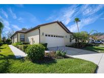 Single-story house with attached garage, landscaping, and walkway at 1410 Maseno Dr, Venice, FL 34292