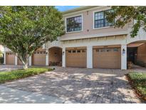 Tan-colored townhouses with two-car garages and neatly landscaped yards at 4007 Overture Cir, Bradenton, FL 34209