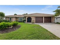 Attractive single-story home with a two-car garage and well-manicured lawn at 416 Giovanni Dr, Nokomis, FL 34275