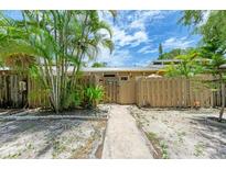 Attractive front yard with walkway, wooden fence, and lush landscaping at 500 N Jefferson Ave # C3, Sarasota, FL 34237