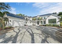 Stunning two-story home with a metal roof and paved driveway at 656 Tropical Cir, Sarasota, FL 34242