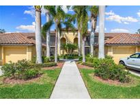 Attractive condo building with palm trees and walkway at 7149 River Hammock Dr # 101, Bradenton, FL 34212