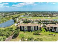 Expansive aerial view of the condo community with lush landscaping, golf course and scenic lakes at 8403 Grand Estuary Trl # 301, Bradenton, FL 34212