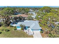 Inviting home with a screened pool, lush landscaping, and a serene neighborhood setting at 1346 Queen Rd, Venice, FL 34293