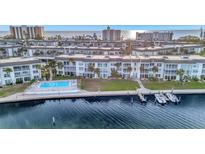 Aerial view of waterfront community with pool, boat slips, and lush landscaping at 4430 Exeter Dr # 104, Longboat Key, FL 34228