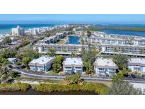 Aerial view of waterfront community with lush landscaping and private boat docks at 527 Sutton Pl # T-12, Longboat Key, FL 34228