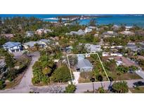 Aerial view of a single-story home with a metal roof, located in a residential neighborhood at 651 Fox St, Longboat Key, FL 34228