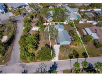 Aerial view showcasing a charming light blue single story home nestled within a residential area at 651 Fox St, Longboat Key, FL 34228