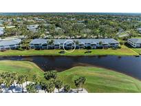 Scenic aerial view of condo community with waterfront and lush landscaping at 6939 W Country Club N Dr # 158, Sarasota, FL 34243