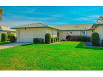 Well-maintained house with a lush lawn and attached garage at 7003 9Th W Ave, Bradenton, FL 34209