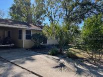 Tan single story house with a large backyard at 1958 Bougainvillea St, Sarasota, FL 34239