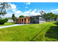 Ranch style home with a large yard and screened porch at 2822 Maple Ave, Sarasota, FL 34234