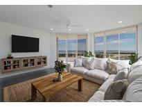 Bright living room with water views, comfy sofas, and a coffee table at 3070 Grand Bay Blvd # 625, Longboat Key, FL 34228