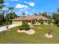 Single-story house with landscaped yard and driveway at 3273 Wentworth St, North Port, FL 34288