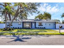 Beautiful single-story home with manicured lawn, updated exterior, and charming curb appeal at 3446 Monica Pkwy, Sarasota, FL 34235