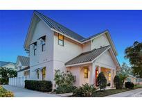 Charming two-story home featuring a modern architectural design, metal roof, and well-manicured landscaping at 515 S Osprey Ave, Sarasota, FL 34236