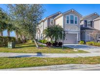 Charming two-story townhome featuring a well-manicured lawn, neutral paint, and attached two-car garage at 5580 Pleasantview Ct, Lakewood Ranch, FL 34211