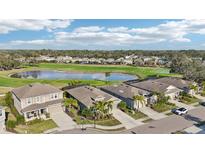 Aerial view showcasing homes near golf course and pond at 7812 Birdie Bend Way, Sarasota, FL 34241