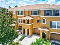 Front view of a three-story townhome with a two-car garage at 7350 Black Walnut Way, Lakewood Ranch, FL 34202