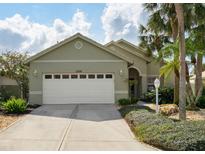 Charming single-story home featuring a two-car garage and manicured landscaping at 1358 Berkshire Ct, Venice, FL 34292