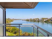 Enjoy waterfront views from this condo balcony, with glass railings and ample space for outdoor seating at 225 Sands Point Rd # 6204, Longboat Key, FL 34228