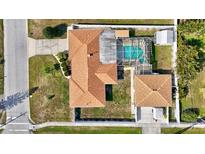 A sunny aerial view of a well-maintained property with a screened pool and fully fenced yard at 2347 Sunnyside Pl, Sarasota, FL 34239