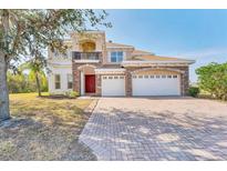 Elegant two-story home with a three-car garage, stone accents, and a manicured front yard at 4307 70Th E Ave, Ellenton, FL 34222